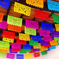 Dia de los Muertos flags hang from ceiling.