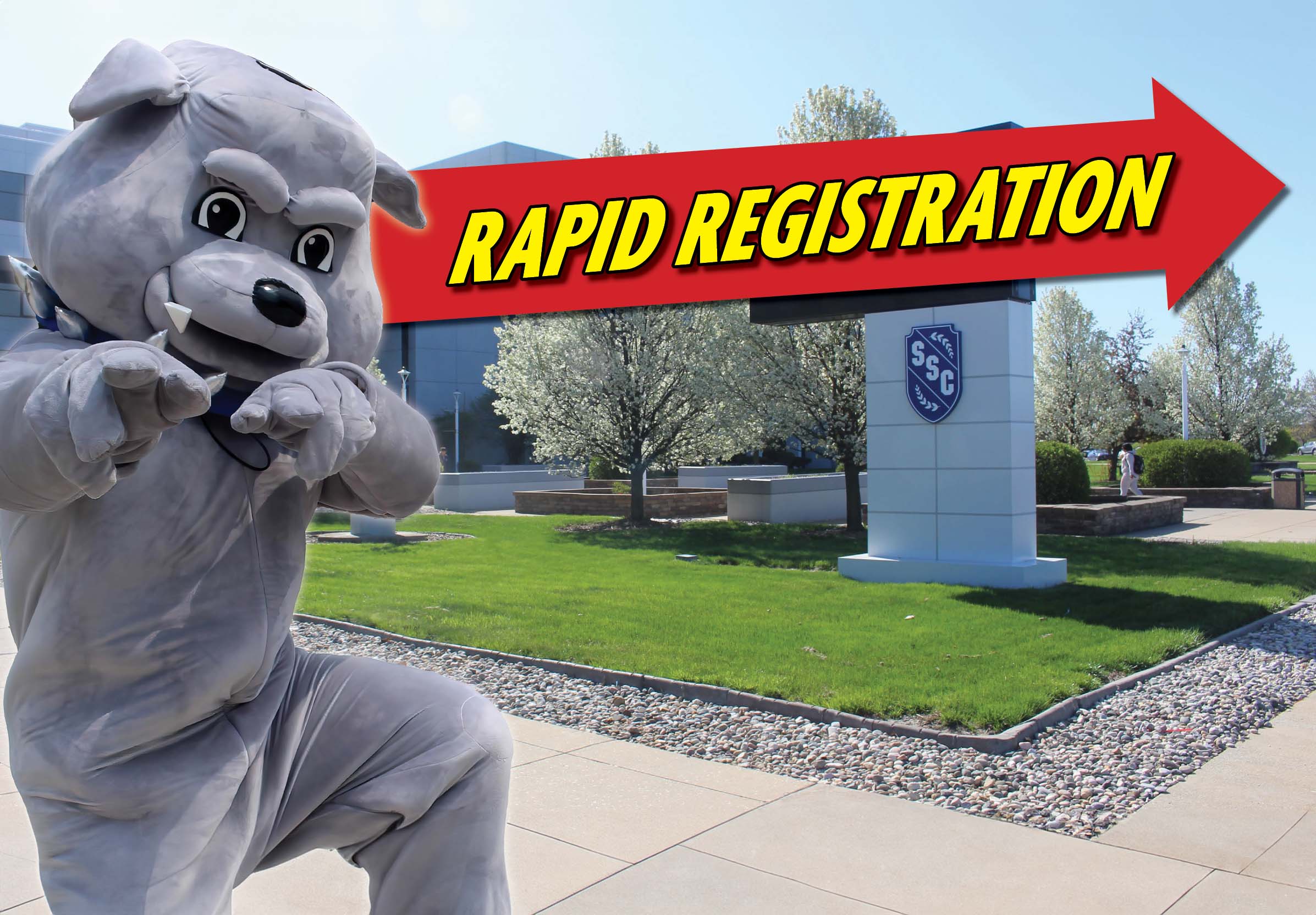 Bulldog mascot in front of the Main Campus entrance with a graphic that says, 