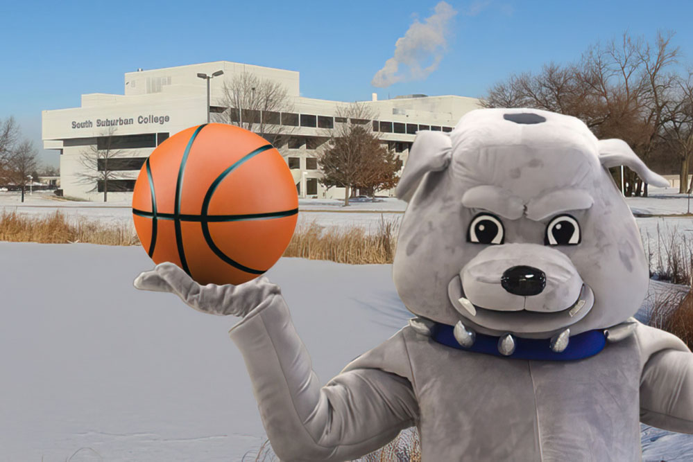 Bruno mascot holding a basketball in front of the Main Campus in winter.