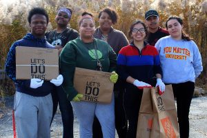 Student volunteers pose at campus clean-up event.